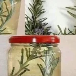 A close-up image of fresh rosemary sprigs and Mix Rosemary with Cloves a rustic setting.