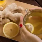 Refreshing homemade Ginger Water with sliced ginger root in a glass