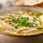 Bowl of Crack Chicken Noodle Soup with tender chicken, noodles, and creamy broth.